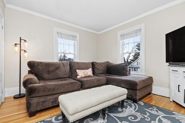 living room with plenty of natural light, light wood-style flooring, and ornamental molding