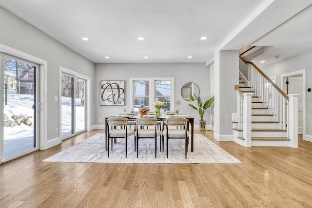 dining room with recessed lighting, stairway, and light wood finished floors