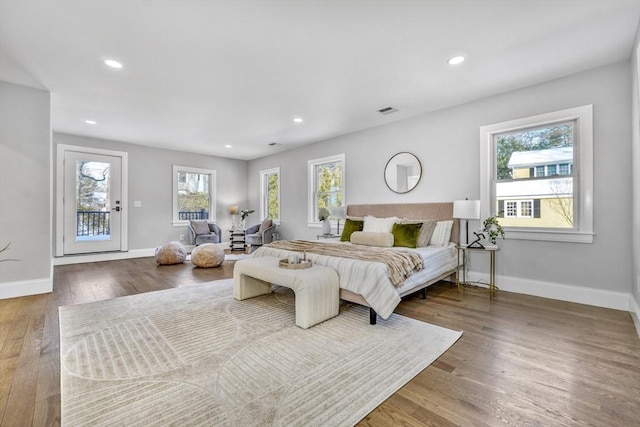 bedroom featuring multiple windows, recessed lighting, wood finished floors, and baseboards