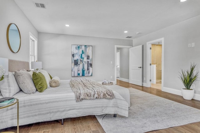 bedroom with baseboards, visible vents, wood finished floors, and recessed lighting