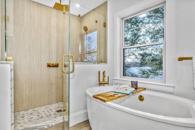 full bath featuring a freestanding bath and a shower stall