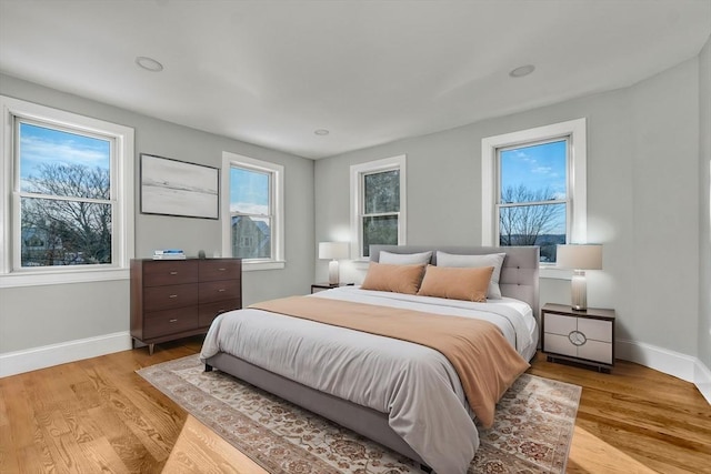 bedroom featuring light wood-style flooring and baseboards