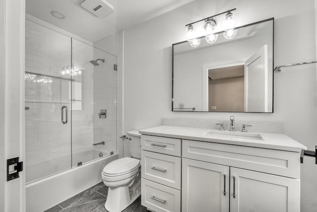 bathroom featuring vanity, toilet, and bath / shower combo with glass door