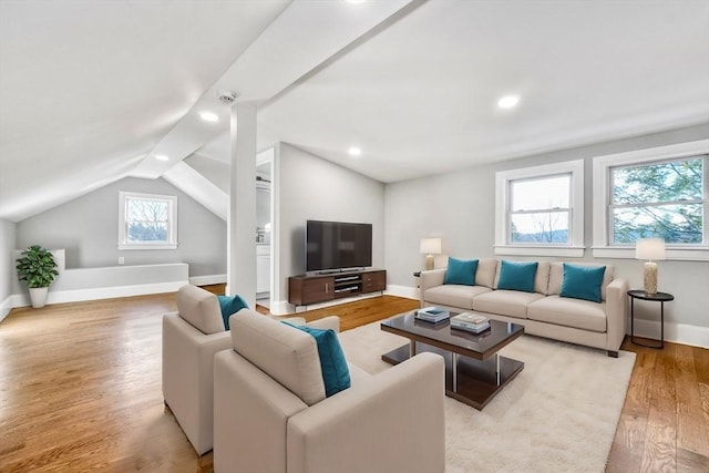 living room featuring lofted ceiling, baseboards, wood finished floors, and recessed lighting