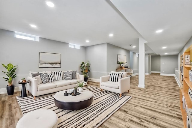 living area with light wood-style floors, recessed lighting, plenty of natural light, and baseboards