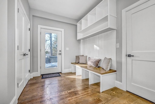 mudroom with wood finished floors and baseboards