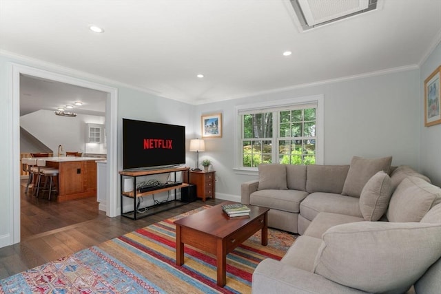 living room with dark wood-style floors, visible vents, baseboards, recessed lighting, and crown molding