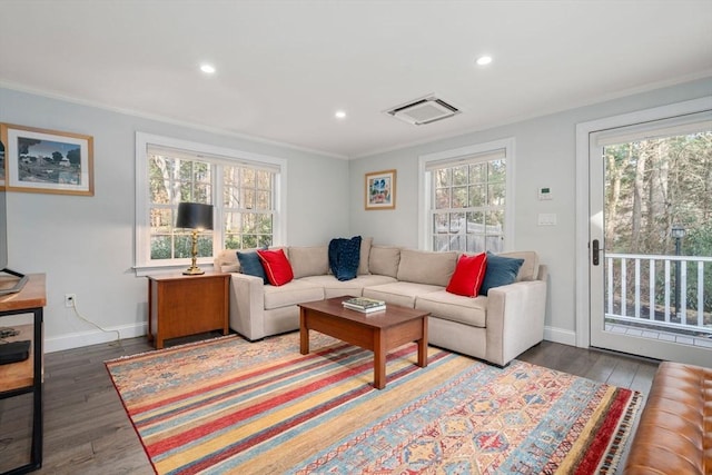 living area featuring a healthy amount of sunlight, baseboards, and wood finished floors