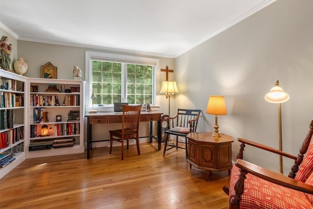 living area with wood finished floors and ornamental molding