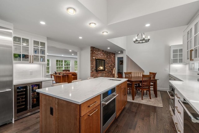 kitchen with decorative backsplash, wine cooler, dark wood-style flooring, and stainless steel appliances