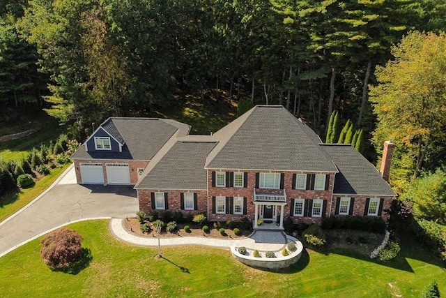 view of front of home with a garage and a front yard