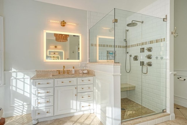 bathroom with tile patterned flooring, vanity, and an enclosed shower