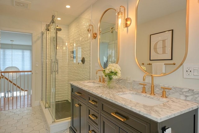 bathroom featuring tile patterned flooring, vanity, and a shower with shower door