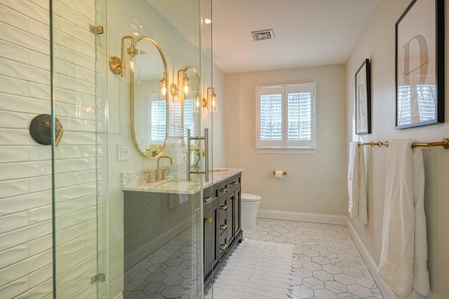 bathroom featuring walk in shower, tile patterned floors, toilet, and vanity