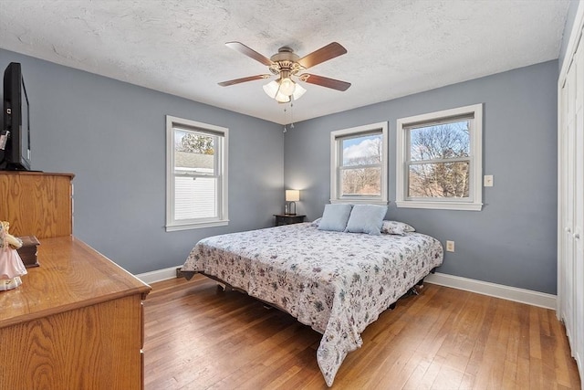 40 Flaggler Rd, Leominster, MA 01453 - bedroom with baseboards, wood-type flooring, a textured ceiling, and a ceiling fan