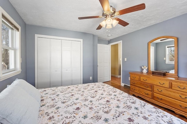 40 Flaggler Rd, Leominster, MA 01453 - bedroom featuring baseboards, wood finished floors, a closet, a textured ceiling, and ceiling fan