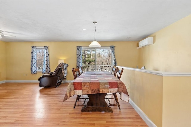 40 Flaggler Rd, Leominster, MA 01453 - dining space with light wood-type flooring, a wall unit AC, and baseboards