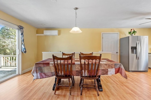 40 Flaggler Rd, Leominster, MA 01453 - dining space featuring a wall unit AC, light wood-style floors, baseboards, and a ceiling fan