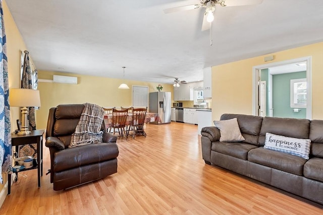 40 Flaggler Rd, Leominster, MA 01453 - living room featuring a ceiling fan, light wood finished floors, and a wall mounted air conditioner
