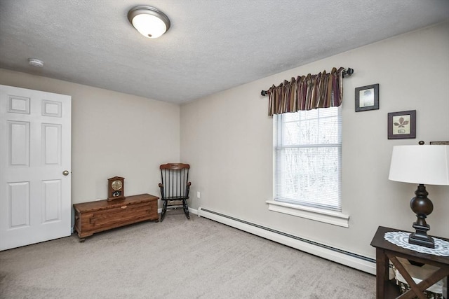 sitting room featuring carpet floors, a textured ceiling, and baseboard heating