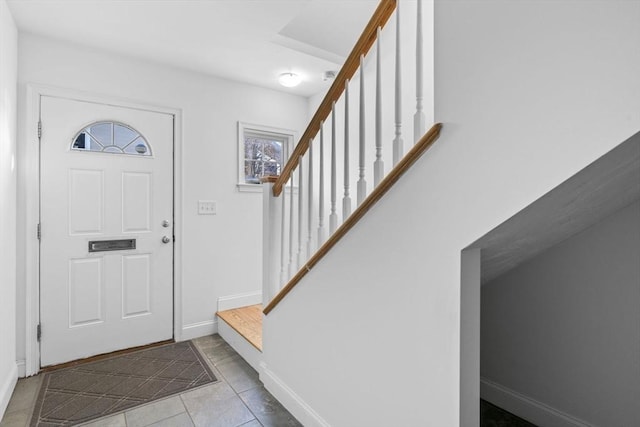 foyer entrance with light tile patterned floors