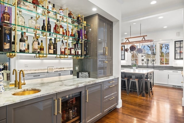 bar with white cabinets, sink, wine cooler, gray cabinets, and dark wood-type flooring