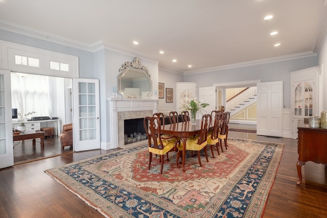 dining area with dark hardwood / wood-style flooring and ornamental molding