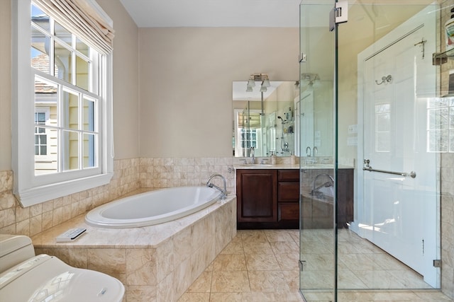 bathroom with tile flooring, large vanity, and plus walk in shower