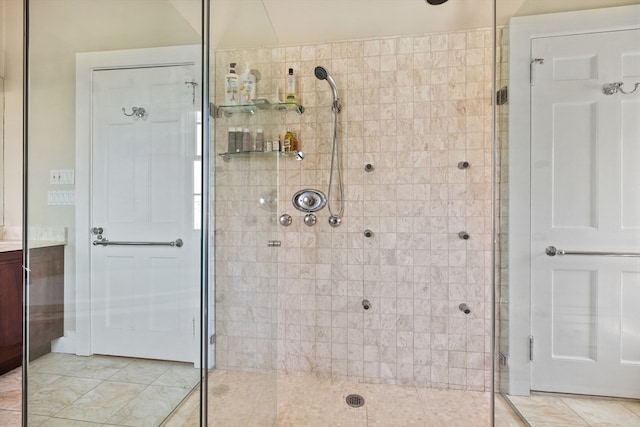 bathroom featuring vanity, an enclosed shower, and tile floors