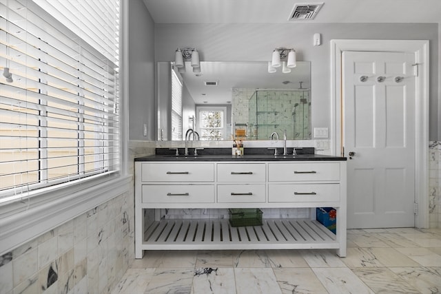 bathroom with dual sinks, tile flooring, and large vanity