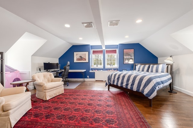 bedroom with dark hardwood / wood-style flooring and vaulted ceiling with beams