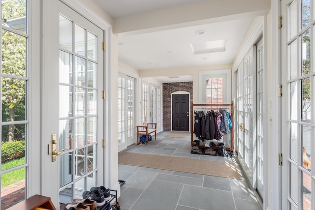 entrance foyer featuring plenty of natural light and light tile floors