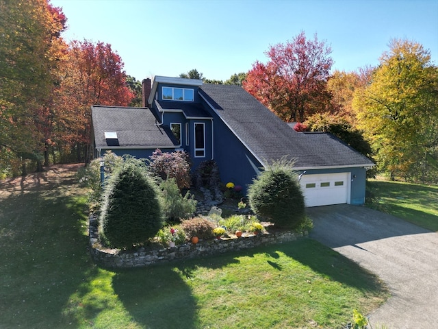 view of front of house featuring a front yard and a garage