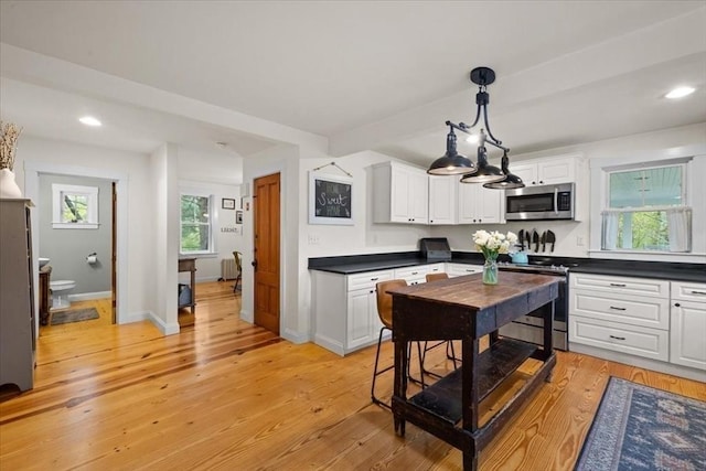44 Prospect Rd, Plympton, MA 02367 - kitchen with stainless steel appliances, dark countertops, white cabinets, light wood finished floors, and recessed lighting
