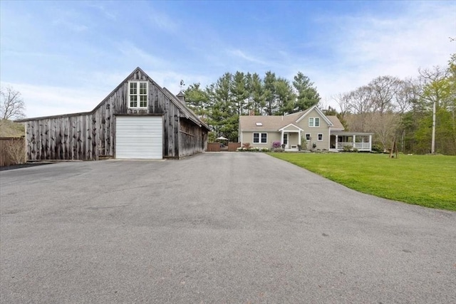 44 Prospect Rd, Plympton, MA 02367 - view of front of house with driveway, a front yard, a detached garage, and an outbuilding