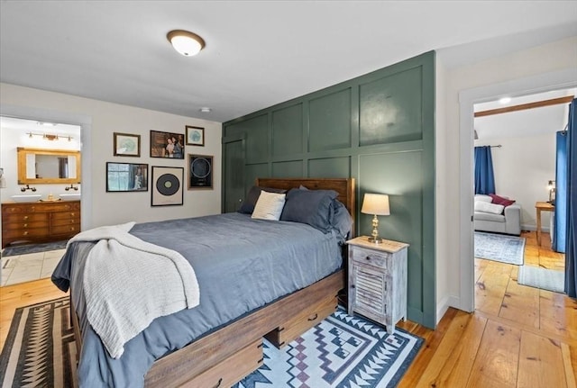44 Prospect Rd, Plympton, MA 02367 - bedroom with light wood-type flooring, a decorative wall, and ensuite bathroom