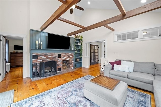 44 Prospect Rd, Plympton, MA 02367 - living room with high vaulted ceiling, a ceiling fan, beamed ceiling, hardwood / wood-style floors, and a brick fireplace