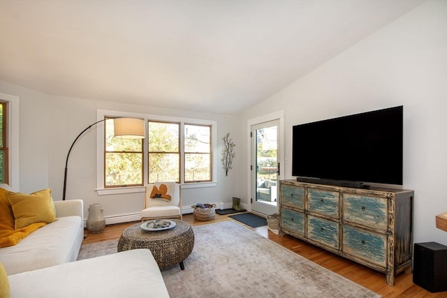 living room featuring hardwood / wood-style floors, a baseboard heating unit, and lofted ceiling