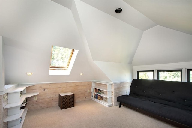 sitting room featuring light carpet and lofted ceiling with skylight