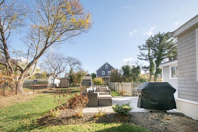 view of yard featuring an outdoor living space, a patio, and a storage unit