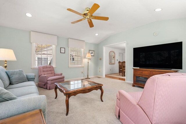 living room with vaulted ceiling, a ceiling fan, recessed lighting, light carpet, and baseboards