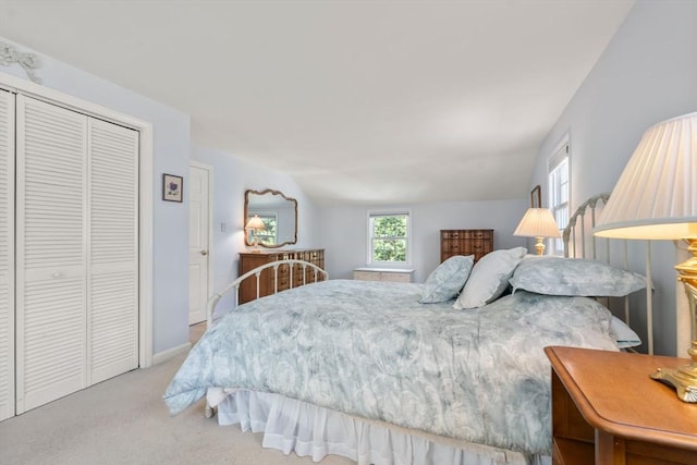carpeted bedroom featuring a closet and baseboards