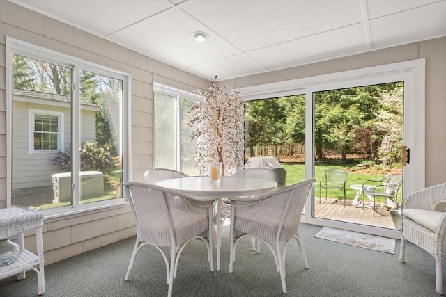 sunroom featuring outdoor dining space