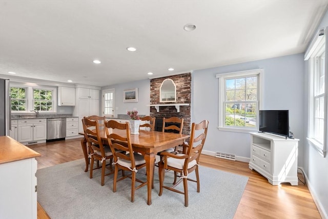 dining area featuring healthy amount of natural light, light wood-style floors, baseboards, and recessed lighting