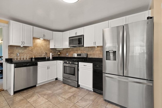 kitchen featuring tasteful backsplash, white cabinetry, appliances with stainless steel finishes, and sink