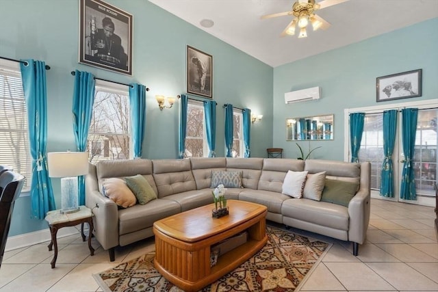living room with light tile patterned flooring, ceiling fan, and a wall unit AC