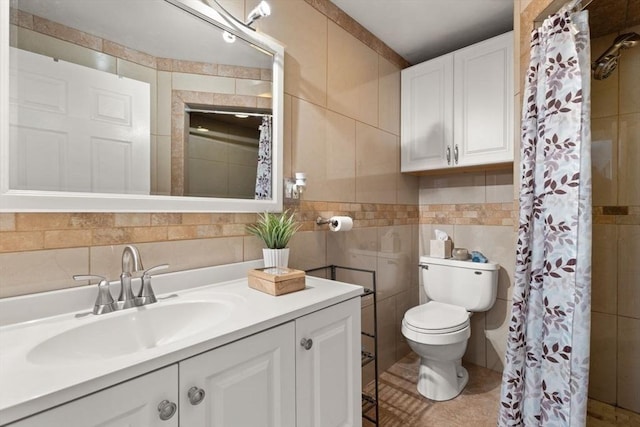 bathroom with tile patterned flooring, vanity, tile walls, and toilet