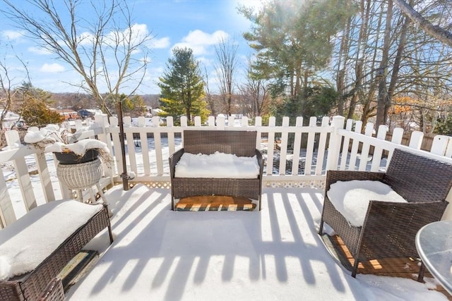view of snow covered back of property