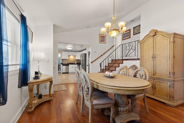 dining area featuring light hardwood / wood-style floors and a notable chandelier