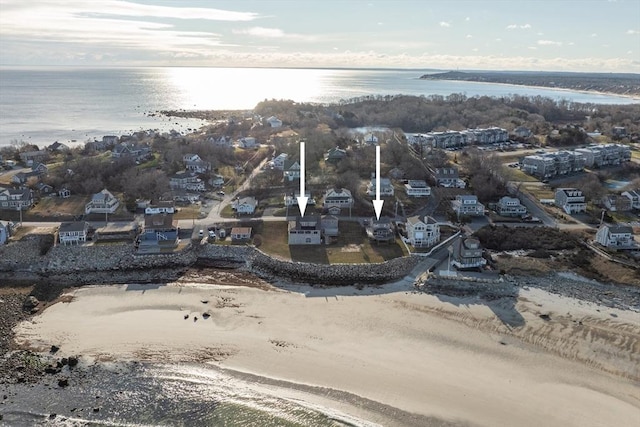 drone / aerial view with a water view and a view of the beach